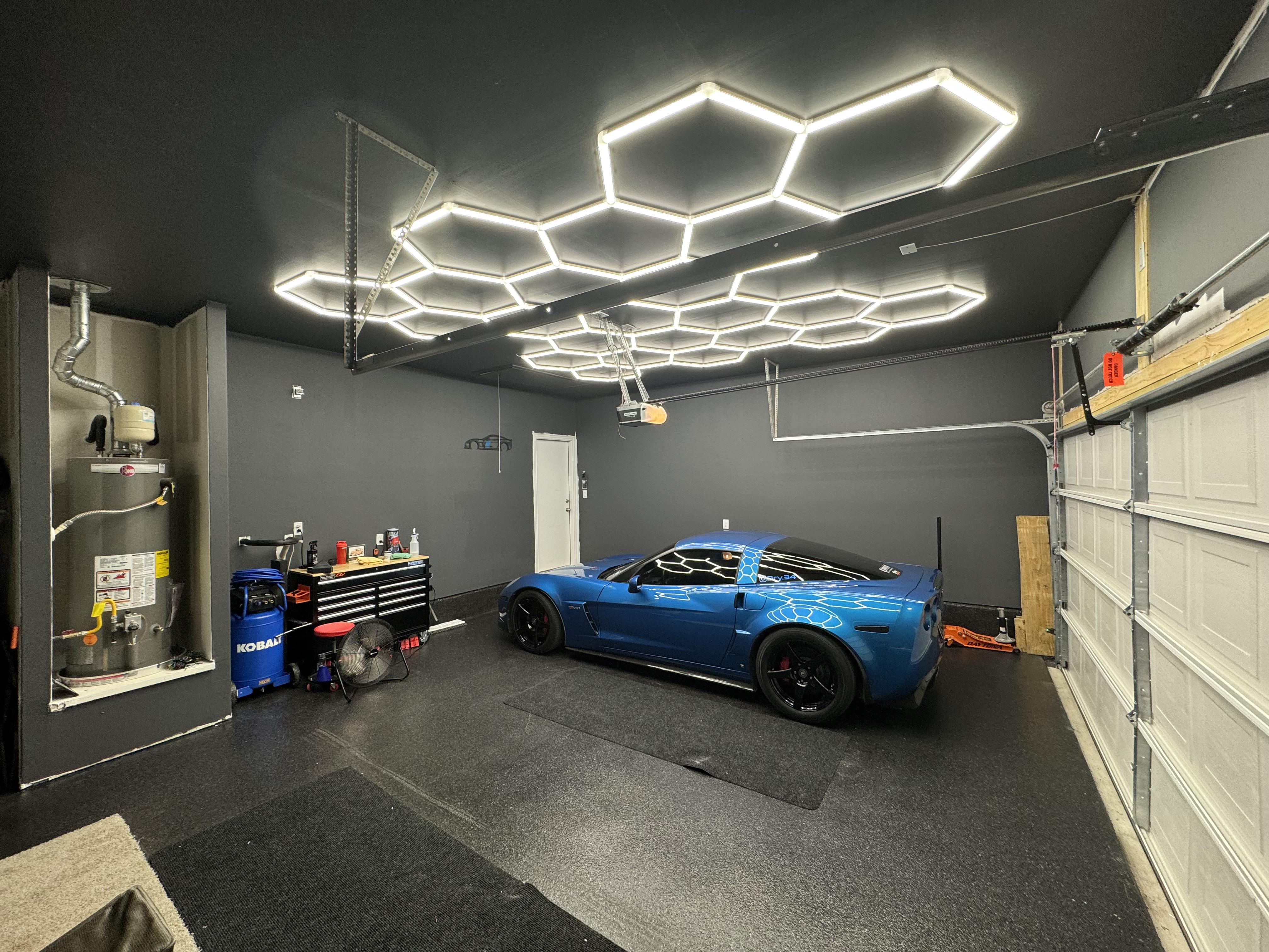 Garage with hexagon LED lighting and epoxy floor
